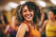 © Anne Schaum - Portrait of a happy young woman smiling while exercising in fitness studio
