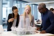 © Anne Schaum - Front view of a diverse group of business people discussing over a building model in a modern office