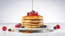 Image Of Pancakes Adorned With A Drizzle Of Maple Syrup And Fresh Berries.