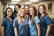© Anne Schaum - Portrait of a group of smiling medical workers standing together in hospital corridor.