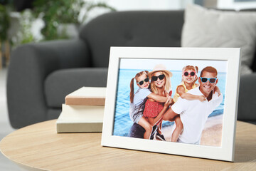 Poster - Frame with family photo and books on coffee table indoors