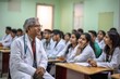 © Anne Schaum - Asian senior male doctor sitting in front of a group of students.