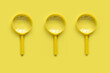 Leinwandbild Motiv Yellow magnifying glass over a yellow background.