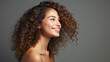 © Nico Vincentini - Portrait of a woman highlighting skincare and beauty cosmetics for a radiant, healthy glow, set against a modern studio background. Cheerful model with beautiful curly hair smiling. Generative AI