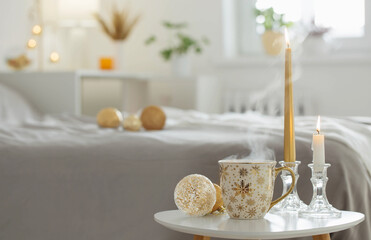 Poster - cup of coffee with christmas balls on little table in white bedroom