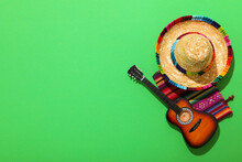 Mexican Carpet, Guitar And Sombrero On Green Background.