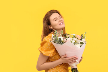 Wall Mural - Happy woman with bouquet of beautiful flowers on yellow background