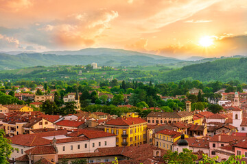 Wall Mural - travel summer view from hill to a nice european town with amazing buildings, green hills and mountains with amazing cloudy evening sky on background