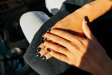 Bad Manicure At The Girl In The Car. Peeling Black Polish On A Woman's Nails. Girl With Old Manicure