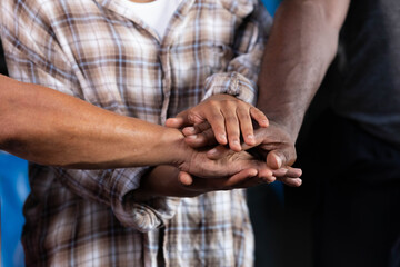 workers joining hands for cooperation success work and project in the factory