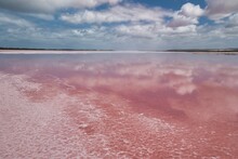 Beautiful And Amazing Pink-colored Lake In Western Australia Called 'Hutt Lagoon'. Stunning Pink Salt Lake Close To Geraldton, WA. Reflections Of The Blue Sky And Clouds In The Deep Pink Water. 