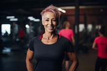 Portrait Of A Smiling Mature Woman With Pink Hair In A Gym