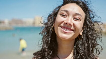 Wall Mural - Young beautiful hispanic woman tourist smiling confident wearing bikini at beach