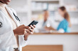 © Talia Mdlungu/peopleimages.com - Woman pharmacist with phone, typing in clinic and research for medical information, email or online chat. Smartphone, networking and mockup, doctor in pharmacy checking social media or internet news