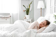 © Pixel-Shot - Young woman sleeping in bed at home