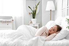 Young Woman Sleeping In Bed At Home