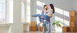 © Studio Romantic - Happy young smiling man holding his girlfriend or wife in his arms celebrating moving day in their new appartment in empty room. Family couple having fun. Relocating, real estate, mortgage concept.