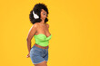 © neonshot - Adorable african american woman with white headphones laughing out loud, dancing, yellow vibrant studio background. Real people emotions
