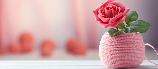 Aufkleber - Blurred background with a knitted element and a rose in a vase