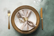 Elegant table setting with golden leaves and cutlery on grey table