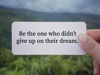 Wall Mural - Motivational and inspirational wording. Be the one who didn’t give up on their dreams written on a paper. With blurred styled background.