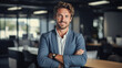 © Phoophinyo - A Portrait of handsome smiling man sitting with arms crossed in office and looking at camera High quality photo with copy space.