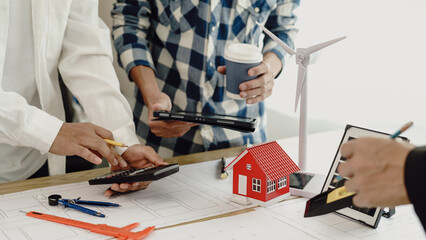 3rd male engineer designing house structure on table in office