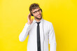 © luismolinero - Telemarketer blonde man working with a headset isolated on yellow background thinking an idea
