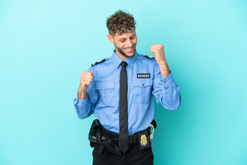 Wall Mural - Young police blonde man isolated white on blue background celebrating a victory