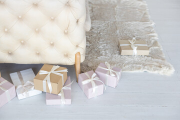 Canvas Print - Beautiful Christmas gift boxes on floor near fir tree in room.