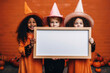Happy halloween kids in costumes with whiteboard mockup