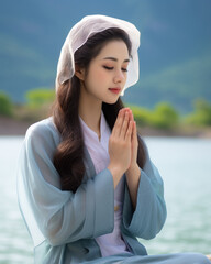 Wall Mural - Young woman wearing traditional Japanese clothing praying to God in beautiful and cool outdoors