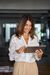 © Stock 4 You - Latin Hispanic 40s years stylish mature professional business woman, smiling European businesswoman CEO holding digital tablet using fintech tab online application standing in modern office, vertical