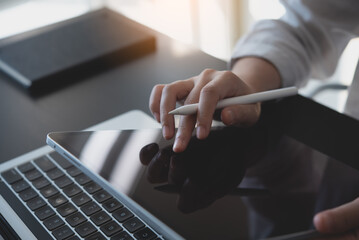 Wall Mural - close up, woman using digital tablet, finger touching on screen and working on laptop computer, surf