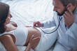 © georgerudy - Pregnant woman visiting a doctor