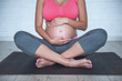 © georgerudy - Pregnant woman doing yoga