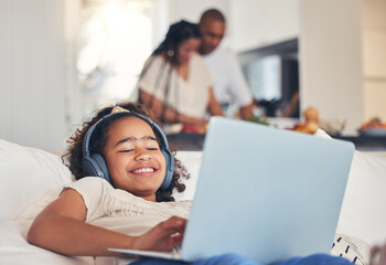 Child, laptop and headphones on sofa for happy video streaming, audio subscription and e learning at home. Kid relax on couch listening to music, games and online education on computer in living room