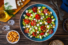 Fresh Vegetable Salad With Feta Cheese On Wooden Table
