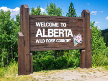 Welcome To Alberta Sign Near The Border Crossing Between Waterton National Park, Canada And Glacier National Park, USA.