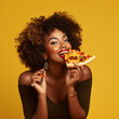 Black woman eating a slice of pizza.