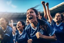 A Group Of Girls - A Female Football Sports Team In Blue Uniform Cheering Because Of Victory In A Game After Making A Goal At The Stadium Or A Soccer Field