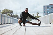 © Azee Jacobs/peopleimages.com - Exercise, outdoor and man stretching, fitness and workout with warm up, freedom and training with health. Athlete, person or runner with wellness, stretch or sports with practice in a city and energy