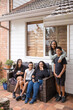 © Austockphoto - First nations family sitting together on couch outside