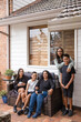 © Austockphoto - First nations family sitting together on couch outside