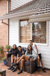 © Austockphoto - First nations family sitting together on couch outside