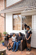 © Austockphoto - First nations family sitting together on couch outside