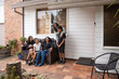 © Austockphoto - First nations family sitting together on couch outside