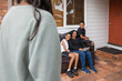 © Austockphoto - First nations family sitting together on couch outside
