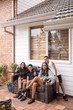 © Austockphoto - First nations family sitting together on couch outside