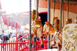 © Austockphoto - Merry-go-round horses at a theme park